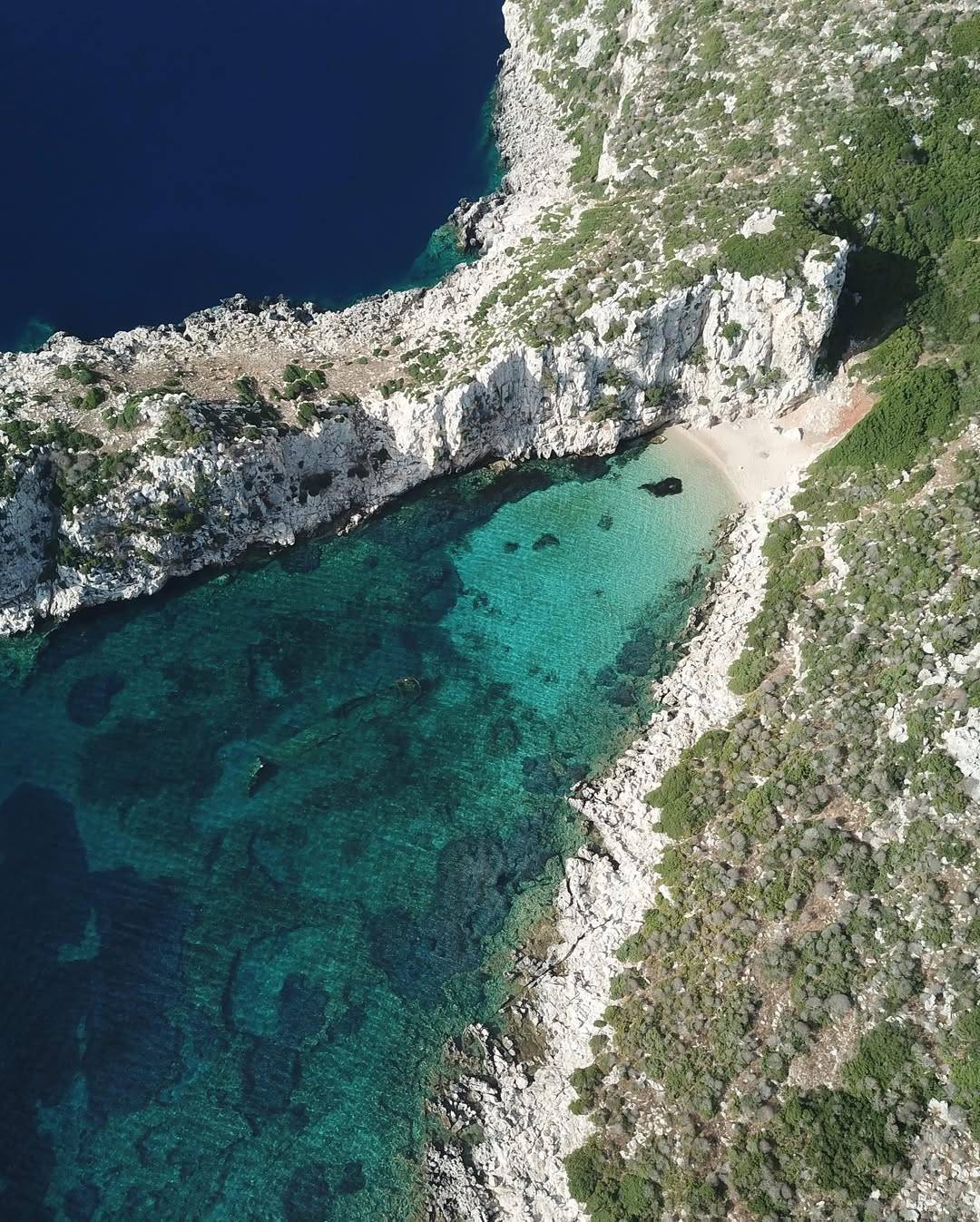 Alegria catamaran is anchored near the rocky coast of Proti Island in Messinia, Greece, surround (2)