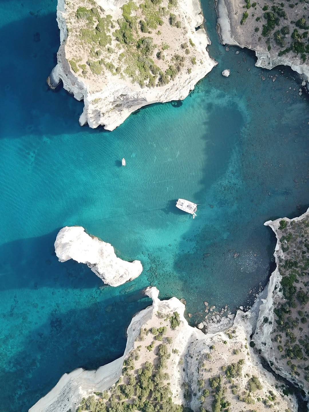 Anchored in the surreal beauty of Sarakiniko, Milos — where white volcanic rocks meet the endles