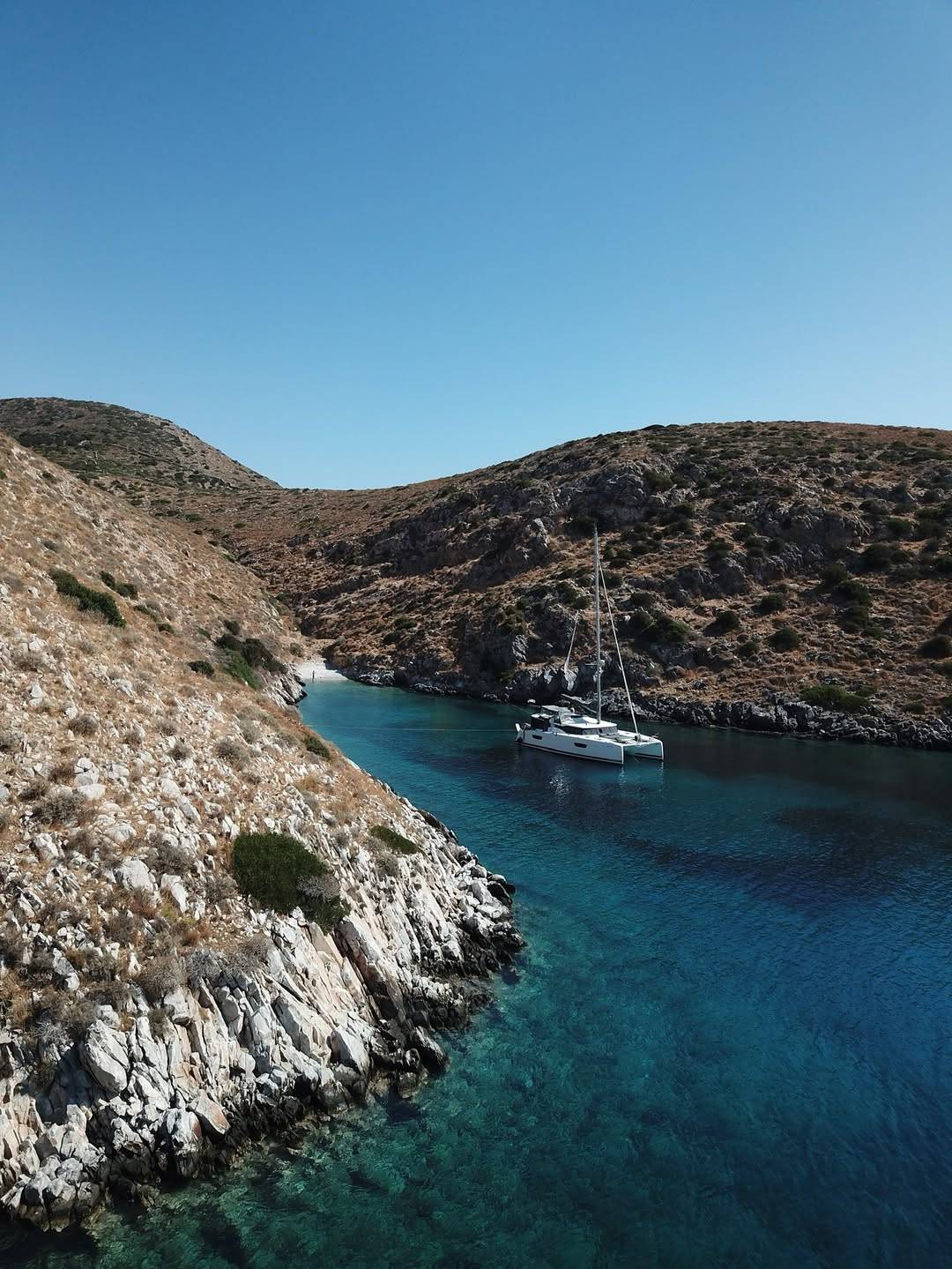 In the peaceful setting of a quiet location in Mani, where gentle waves rock the Catamaran, we f (1)